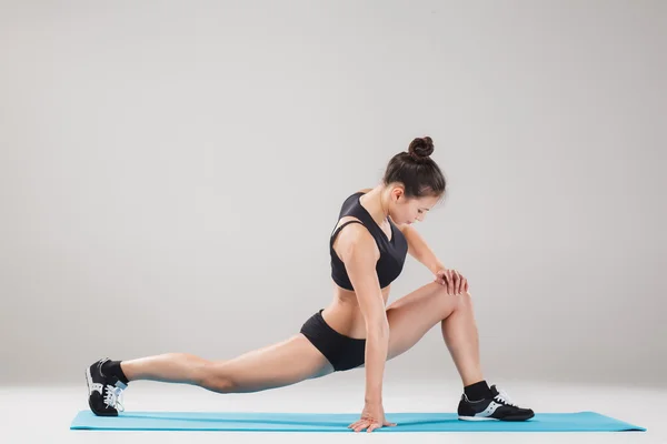 Hermosa chica deportiva de pie en pose acróbata o yoga asana —  Fotos de Stock