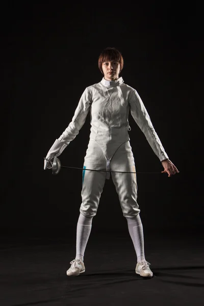 The portrait of woman wearing white fencing costume  on black