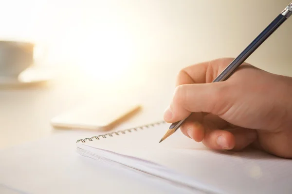 The male hand with a pencil and the cup — Stock Photo, Image