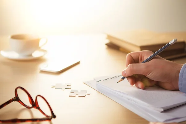 The male hands with a pencil and the cup — Stock Photo, Image