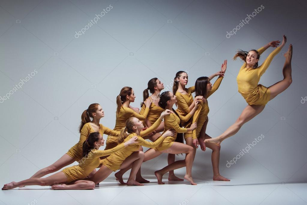 The Power Of A Moment. A Group Of Dancers Performing A Dramatic Pose In  Front Of A Dark Background. Stock Photo, Picture and Royalty Free Image.  Image 194655106.