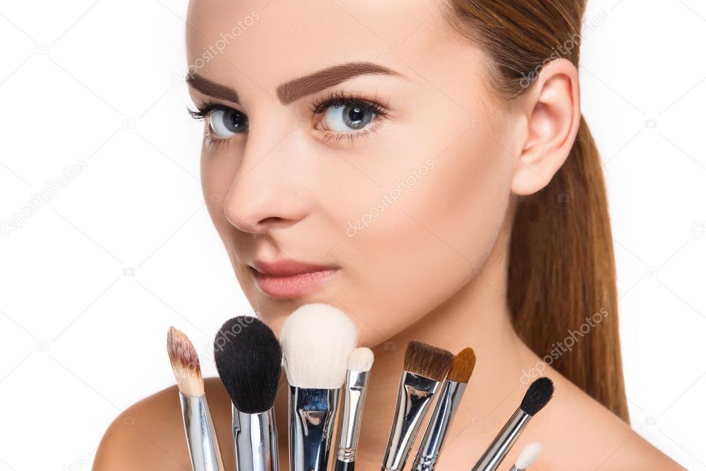 Beautiful female eyes with make-up and brushes