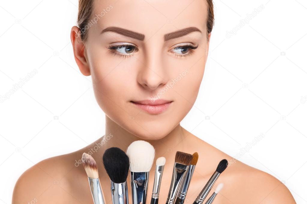 Beautiful female eyes with make-up and brushes