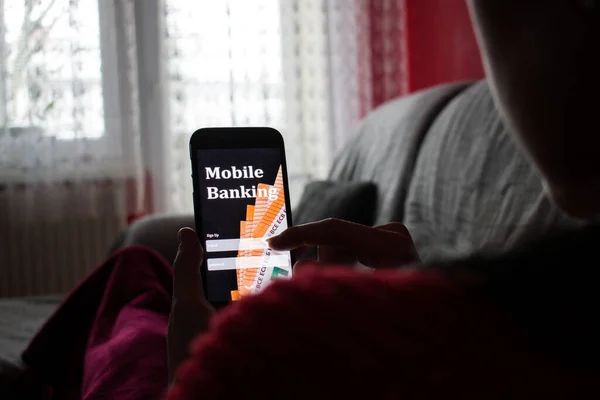 Young woman in the bed using smartphone close up. Mobile banking concept