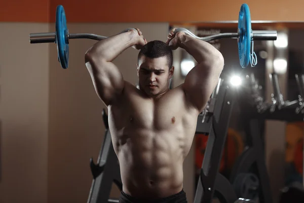 Fitness homme exercice avec haltère dans la salle de gym — Photo