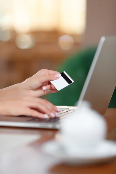 Hands holding credit card and using laptop — Stock Photo, Image