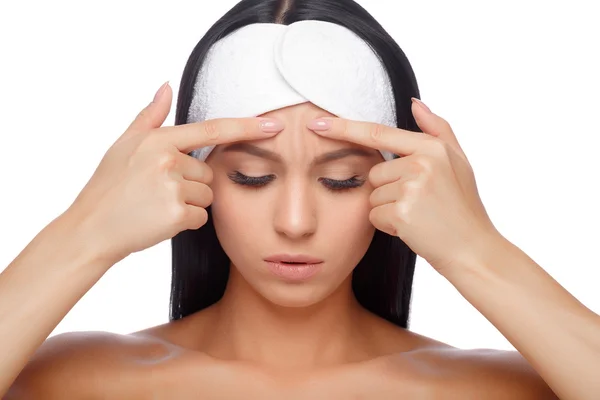 Young woman squeezing her pimple — Stock Photo, Image