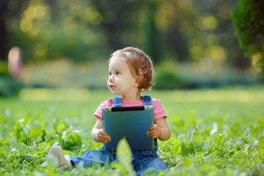 Açık havada tablet ile oynayan çocuk