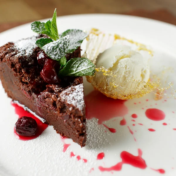 Chocolate brownie with cherries and vanilla ice cream