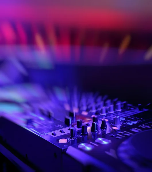 DJ mixer with light colored spotlights discos — Stock Photo © lyashik