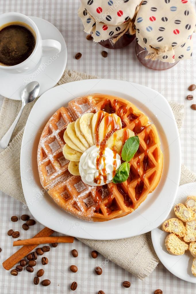 Belgian waffles with bananas and whipped cream