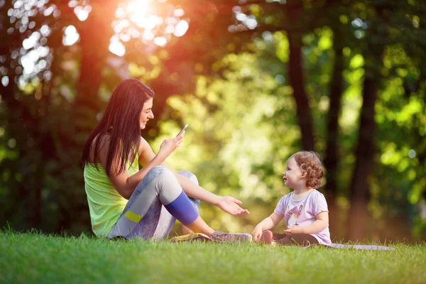 Athletic girl with child doing exercises — Stock Photo, Image