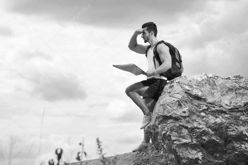 Black and white photo of a tourist with backpack