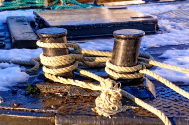 Gray ropes tied to cum on the fishing boat clipart