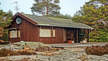 Norwegian summer cabin among rocks clipart