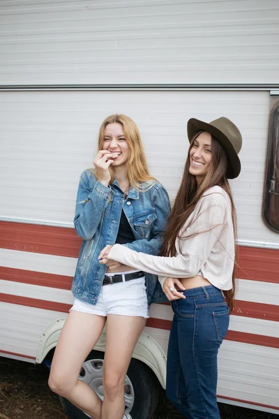 Duas meninas sorrindo apoiadas em uma van . — Fotografia de Stock