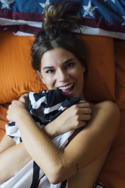 Frau liegt mit Decke in der Hand im Bett — Stockfoto