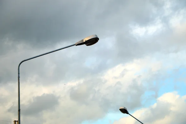 light pole under the blue sky , light pole under the cloudy on evening time ,Light pole open on afternoon under the blue sky