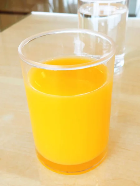Glass of orange juice put on pastel table background, Drink of refreshing juices, water, breakfast