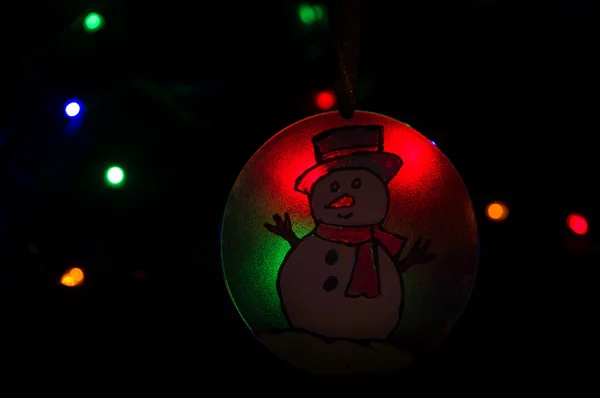 Snowman ornament in glowing red and green lights. — Stock Photo, Image