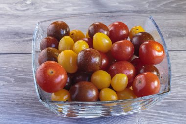 Cam bir kasede farklı renkte domatesler. Moda vejetaryen yemekleri..