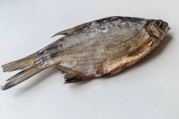 Beyaz arka plan üzerinde kurumuş tuzlu balık yakın çekim.
