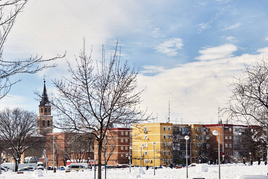 Snowy view of the Parroquia San Pedro Ad Vincula Madrid from Sierra Gorda street. Tormenta Filomena