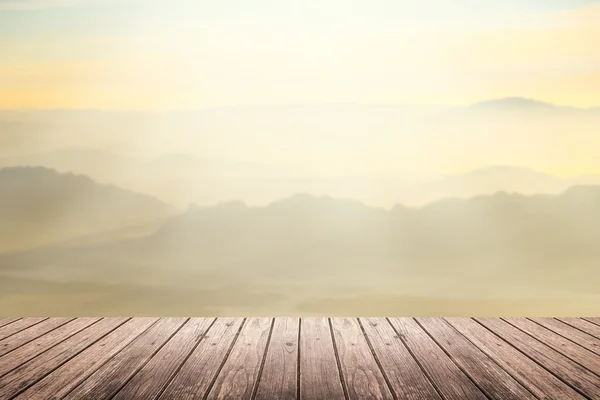 Wooden floor with mountain blurred background — Stockfoto