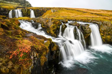Waterfall near Kirkjufell, natural landmark of Iceland clipart