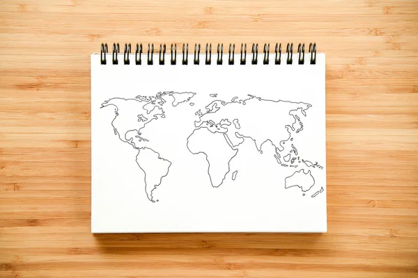 Mapa do mundo esboço no notebook — Fotografia de Stock