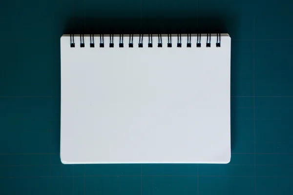 Notebook on cutting mat — Stock Photo, Image
