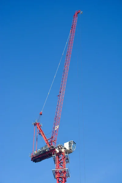Red construction crane on clear sky — Stock Photo, Image