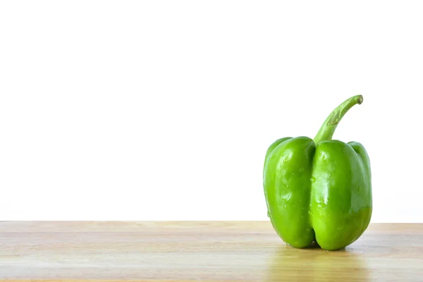 Green pepper on wooden table — Stock Photo, Image