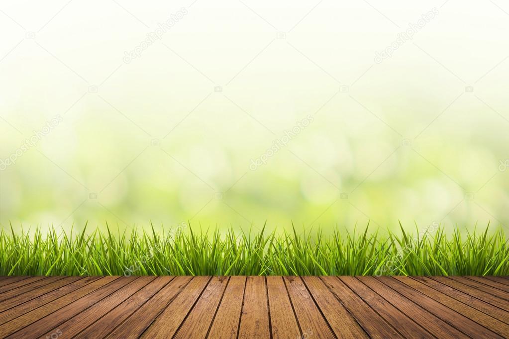 grass with green blurred background and wood floor