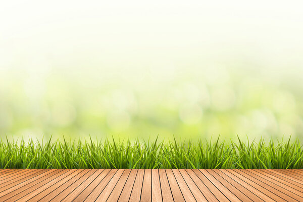 grass with green blurred background and wood floor