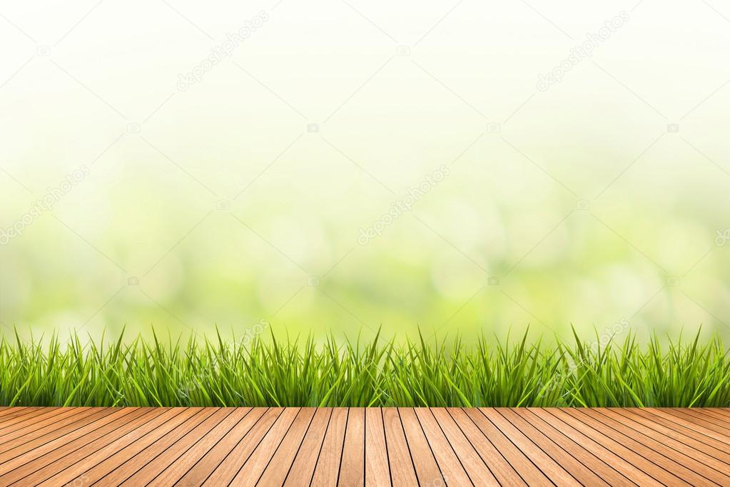 grass with green blurred background and wood floor