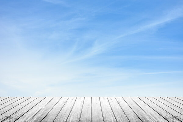 White grunge wooden floor and blur sky with cirrus clouds, use for background or backdrop in nature concept
