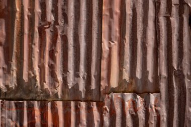 Old rusty zinc panel wall texture. Weathered galvanized steel sheet fence. Rustic material background for retro concept