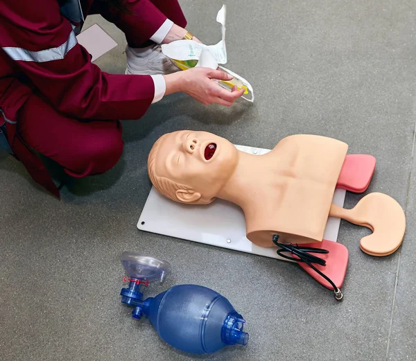 CPR first aid resuscitation adult man life size training dummy model, doll face closeup, detail, mannequin mouth wide open, medical equipment. Paramedic class training simple props abstract concept