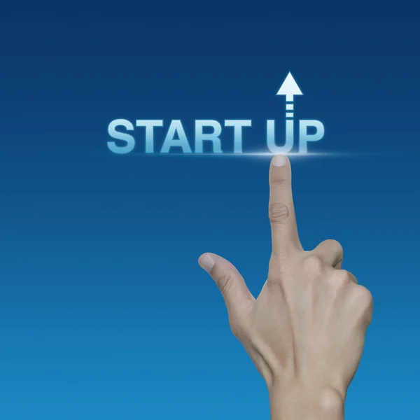 Hand click on start up icon over blue background, Start up busin — Stock Photo, Image