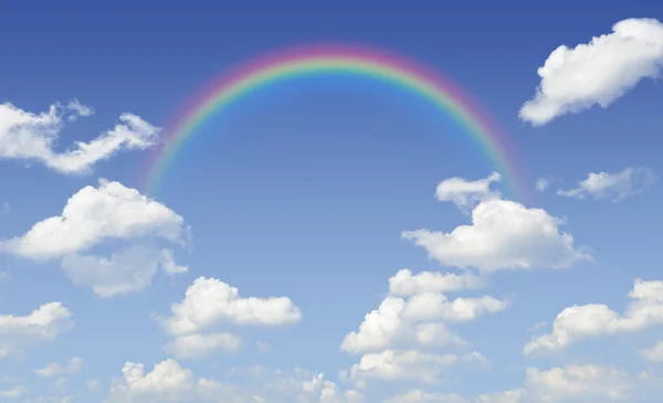 Rainbow with white clouds over blue sky — Stock Photo, Image