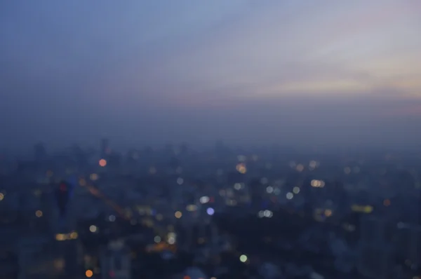 Blurred aerial view of cityscape on warm light sundown, Bangkok — Stock Photo, Image