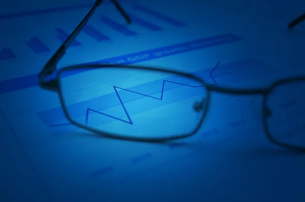 Rise up graph with glasses on financial chart and graph — Stock Photo, Image