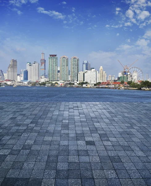 Stone tile floor with city tower and river background — Stock Photo, Image