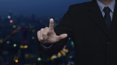 Businessman pressing cross shape with shield flat icon over blur colorful night light modern city tower and skyscraper, Business healthy and medical care insurance concept