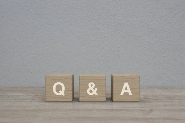 Letter Block Cubes Wooden Table White Wall Background Frequently Asked — Stock Photo, Image