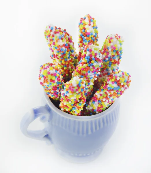 Biscuit stick coated with rainbow — Stock Photo, Image
