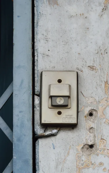 Old plastic door bell on the grunge wall Stock Image