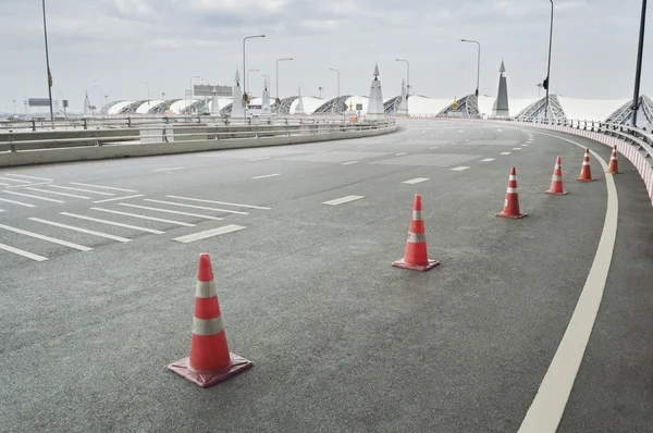 交通锥放置的弯曲的道路上 — 图库照片