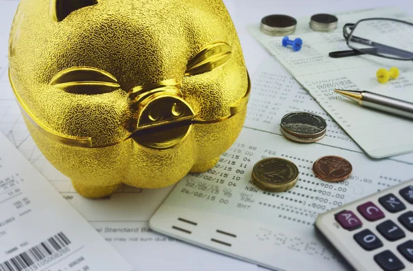 Gold piggy bank with coin on saving account book